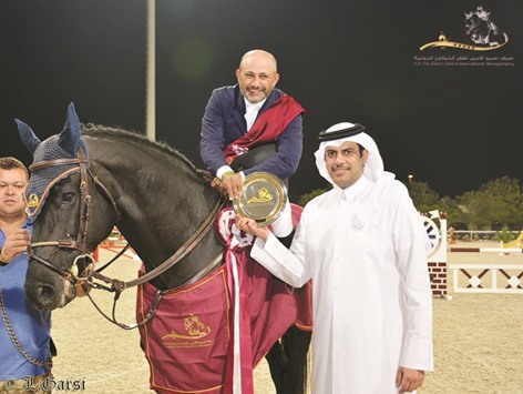 Ramzy Hamad al-Duhami receives the trophy from Qatar Equestrian Federation president Hamad bin Abdulrahman al-Attiyah yesterday.