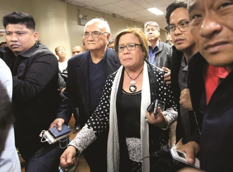 Philippine Senator Leila de Lima is escorted by the Senateu2019s security personnel after a Regional Trial Court (RTC) ordered her arrest, at the Senate headquarters in Pasay city, metro Manila.