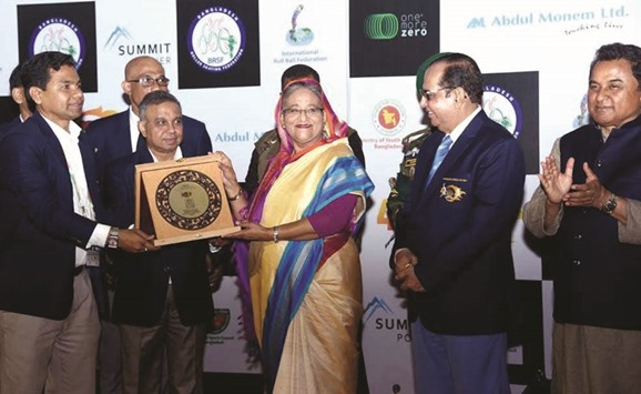 Prime Minister Sheikh Hasina receives a crest on the concluding day of the 4th Roll Ball World Cup held at Sheikh Russell Roller Skating Complex in Dhaka yesterday.