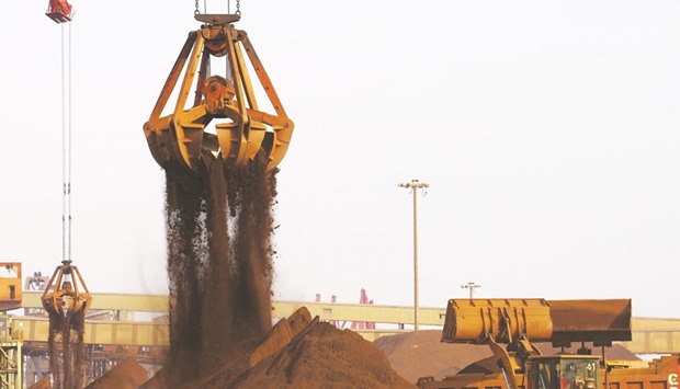 Cranes unload imported iron ore from a ship at a port in Rizhao, China. Iron oreu2019s rally to the highest level since 2014 has been so strong even the industryu2019s champions are flagging the possibility of a pullback.