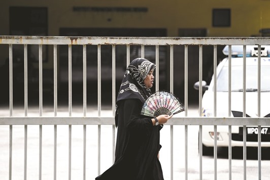 A Malaysian woman walks past the forensics wing of the hospital in Kuala Lumpur where the body of Kim Jong-nam, the half-brother of North Korean leader Kim Jong-un, is being kept.