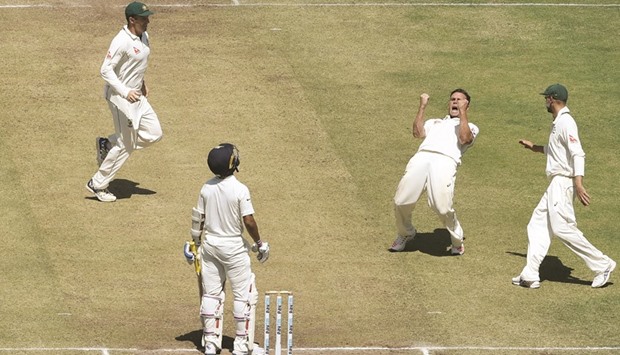 Australiau2019s Steve Ou2019Keefe (C) celebrates after the dismissal of Indiau2019s Ajinkya Rahane during the second day of the first cricket Test match in Pune yesterday.