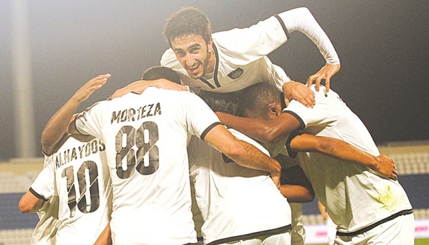 Al Sadd players celebrate one of their goals against Al Khor in the QSL yesterday.
