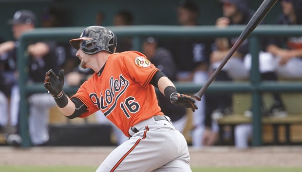 Baltimore Orioles second baseman Johnny Giavotella hits a single to right field during the inning of a spring training baseball game against the Baltimore Orioles at Joker Marchant Stadium.