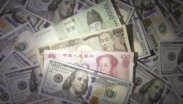 South Korean won, Chinese yuan, Japanese yen and 100 US dollar notes are seen in this file photo. Falling Asian currencies volatility is attracting investors to the regionu2019s bonds as they seek stable returns while waiting for political risk events in the US and Europe to unfold.