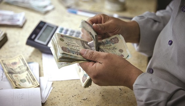 A man counts Egyptian pounds banknotes at a foreign currency exchange bureau in Cairo. Nearly four months after a free float opened the floodgates for overseas funds and sent the currency on a world-beating rally, the government got an unpleasant jolt. Foreign investors, who had been almost the sole buyers at Egyptu2019s local treasury bill auctions earlier this month, were absent for two straight sales.