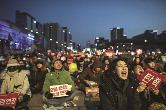Anti-government activists shout slogans during a protest in central Seoul.