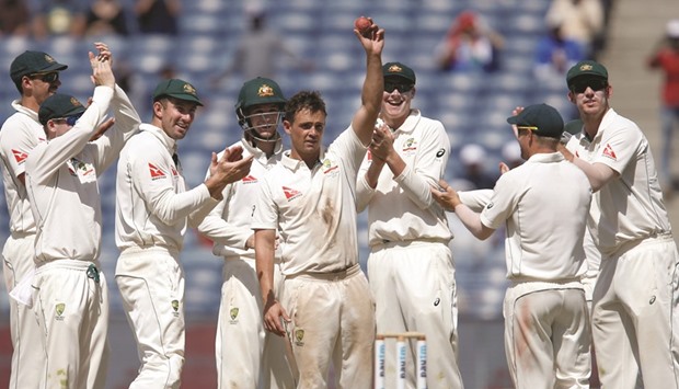 Australiau2019s Steve Ou2019Keefe celebrates with teammates after taking the wicket of Indiau2019s Wriddhiman Saha in Pune yesterday. (Reuters)