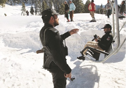 A policeman stands guard at the base of the chairlift to the ski resort in Malam Jabba.