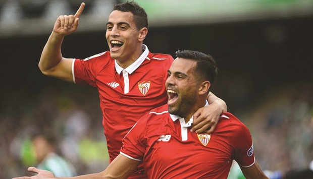 Sevillau2019s defender Gabriel Mercado (R) celebrates after scoring a goal with forward Wissam Ben Yedder (L) during their LA Liga match against Real Betis in Sevilla yesterday. (AFP)