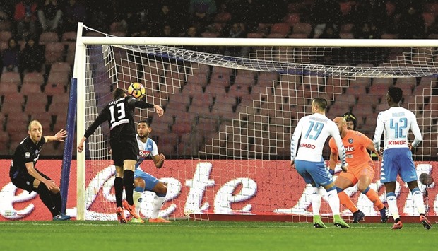 Atalantau2019s defender Mattia Caldara (L) scores a goal against Napoli during their Serie A match at San Paolo stadium in Naples yesterday. (AFP)