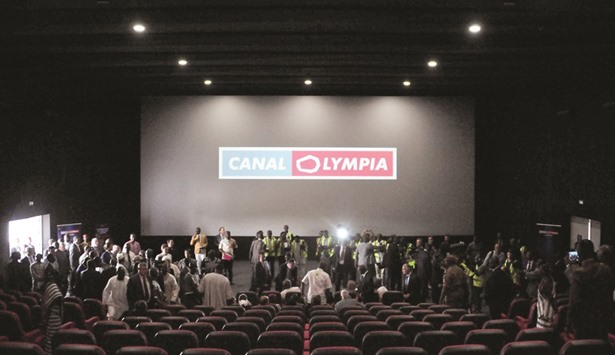 People are seen at the new movie theatre which runs on solar power during its inauguration in Ouagadougou on Friday night, on the eve of the opening of the Pan-African Film and Television Festival (FESPACO).