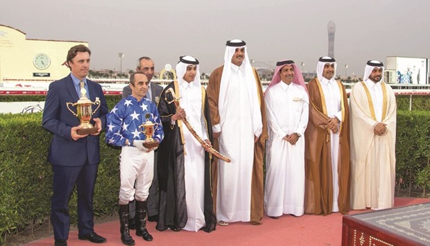 HH the Emir Sheikh Tamim bin Hamad al-Thani, Qatar Racing and Equestrian Club (QREC) chairman Issa al-Mohannadi (second from right), QREC general manager Nasser Sherida al-Kaabi (right) and Total E&P Qatar managing director Guillaume Chalmin (third from left) with the winners of HH The Emiru2019s Sword (Gr1 PA) after Julian Smart-trained Ebraz, owned by HH Sheikh Mohamed bin Khalifa al-Thani, won the 2,400m race yesterday.