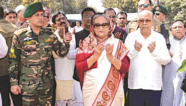 Bangladesh Prime Minister Sheikh Hasina offers prayers before inaugurating a solar-powered food warehouse in Rajshahi yesterday.