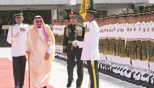 Saudi Arabiau2019s King Salman reviews the honour guard during a welcoming ceremony in Kuala Lumpur yesterday.