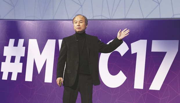 Masayoshi Son, president and chief executive officer of Softbank, delivers his keynote speech at Mobile World Congress in Barcelona, Spain, yesterday. The firm has made a string of surprising acquisitions and investments over the past months, most recently an all-cash deal to buy asset manager Fortress Investment Group.