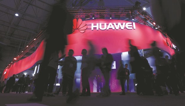 Visitors walk past Huaweiu2019s booth during Mobile World Congress in Barcelona, Spain. The Chinese firm, which has taken aim in recent years at both Samsung and Apple in the high end of the market, presented a new flagship model, the P10 and the larger P10 Plus on Sunday, the eve of the official start of the fair yesterday.