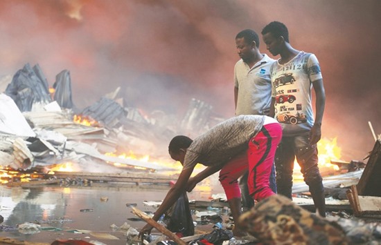 Somali traders attempt to salvage some of their wares from the burning stalls at the main Bakara market in Mogadishu.