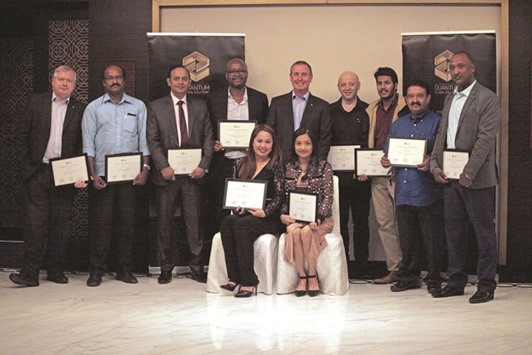 Long service employees pose with their certificates at the Quantum Long Service Awards ceremony.