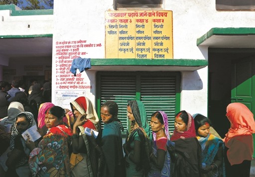 Women queue up to vote during the state assembly election, in the town of Ayodhya, Uttar Pradesh, yesterday.
