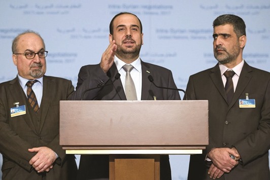 Syriau2019s main opposition High Negotiations Committee (HNC) leader Nasr al-Hariri (centre) gestures between members of the delegation Abdulahad Astepho (left) and Bashar al-Zouabi during a press conference on Syria peace talks  in Geneva yesterday.