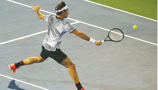 Switzerlandu2019s Roger Federer in action against Benoit Paire of France during their first round match in the Dubai Tennis Championship yesterday. (Reuters)