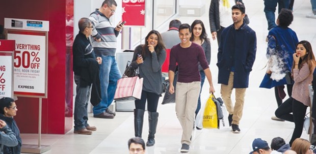 Shoppers walk through the Menlo Park Mall in Edison, New Jersey. Consumer spending, which accounts for more than two-thirds of US economic activity, was revised sharply higher to a 3.0% rate of growth in the fourth quarter.