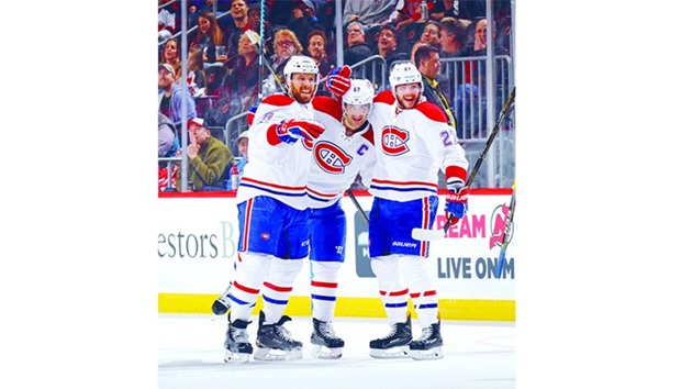 (L-R) Shea Weber, Max Pacioretty and Alex Galchenyuk of the Montreal Canadiens celebrate Max Paciorettyu2019s game tying goal of the third period at the Prudential Centre in Newark, New Jersey. (Getty Images/AFP)