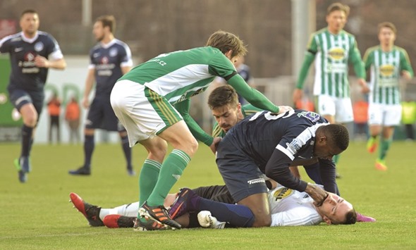 This picture shows Togolese striker Francis Kone (R Up) of FC Slovacko as he gives first aid to Bohemians goal keeper Martin Berkovec.