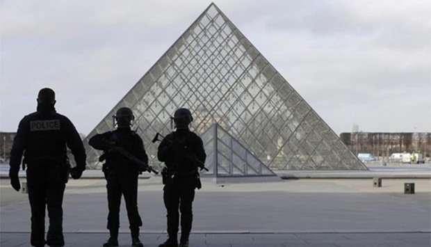 French police secure the site near the Louvre Pyramid in Paris on Friday.