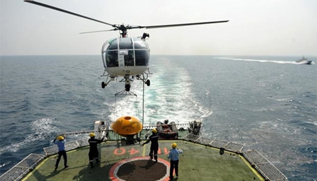 An Indian Coast Guard helicopter carries an Oil Spill Disperser (OSD) off the coastguard ship 'Varad' during a sortie over the waters of the Bay of Bengal, off the coast of Chennai, on Friday.