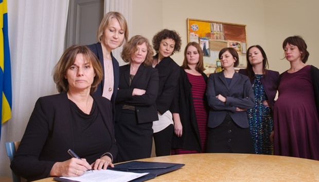 Swedish Environment Minister and Deputy Prime Minister Isabella Lovin (L) signs a referral of Swedish climate law, binding all future governments to net zero emissions by 2045 at the ministry in Stockholm on February 1, 2017.