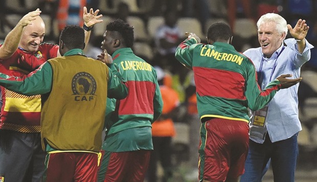 Cameroonu2019s Belgian coach Hugo Broos (R) celebrates with players at the end of the Africa Cup of Nations semi-final against Ghana.