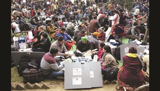 Election officials examine the Electronic Voting Machines (EVM) and other voting materials at a distribution centre in Jalandhar, Punjab yesterday.