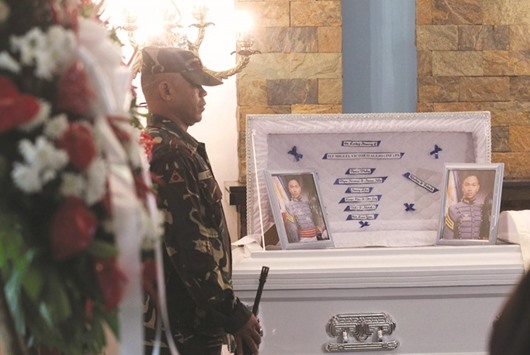 A soldier stands guard beside the coffin of Second Lieutenant Miguel Victor Alejo, who according to authorities was killed by members of rebel group New Peopleu2019s Army (NPA) on Wednesday, the same day the group announced that it is halting the unilateral ceasefire, inside a funeral home in Davao city, southern Philippines.