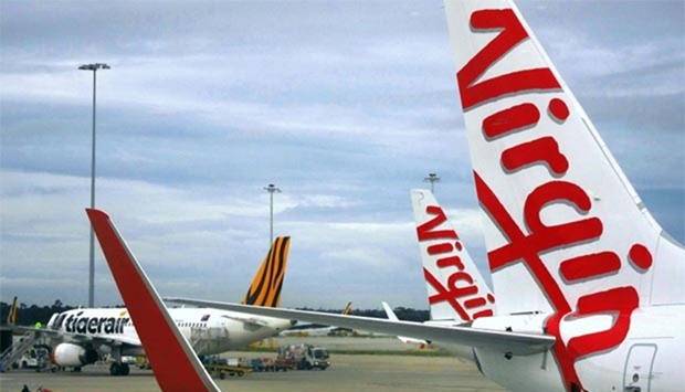 A Tigerair Australia plane sits on the tarmac near Virgin Australia aircraft at Melbourne's Tullamarine International Airport.