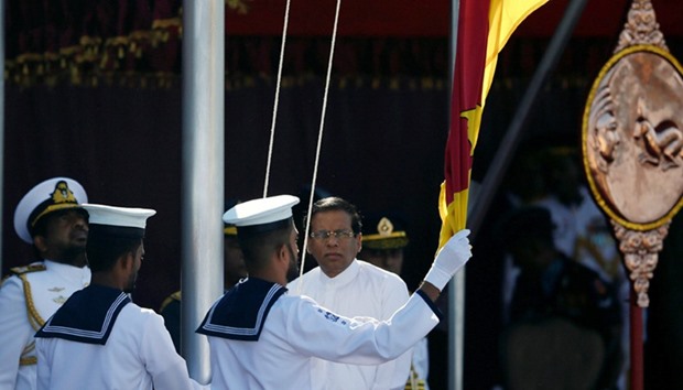 Sri Lanka\'s president Maithripala Sirisena raises the national flag during Sri Lanka\'s 69th Independ