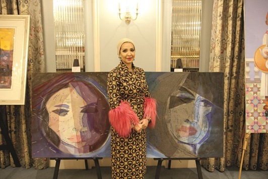 Amal al-Aathem with her paintings at Konooz Art Auction London 2017.