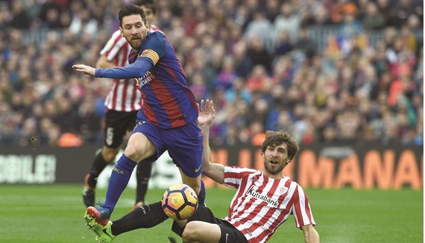 Barcelonau2019s Lionel Messi (left) gets past Athletic Bilbaou2019s Yeray Alvarez during the Spanish league match at the Camp Nou stadium in Barcelona. (AFP)
