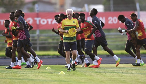 Cameroonu2019s players run as coach Hugo Broos (centre) gets ready for a training session in Libreville yesterday, on the eve Africa Cup of Nations final. (AFP)