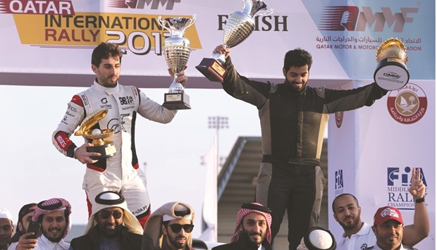 Rashed al-Naimi (right) and Hugo Magalhaes celebrate their win in the Qatar International Rally.