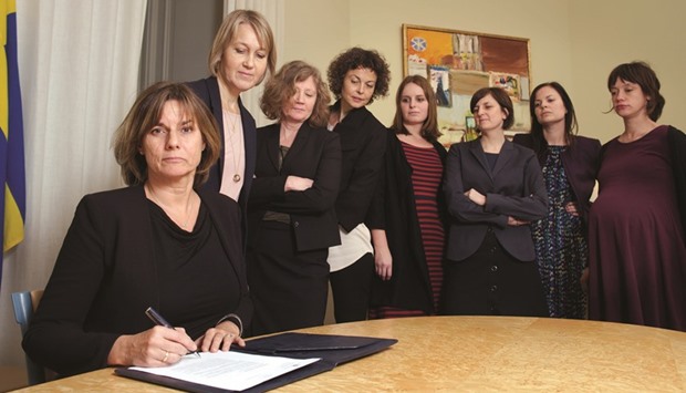 Lovin signs a referral of Swedish climate law, binding all future governments to net zero emissions by 2045, at the ministry in Stockholm on February 1. The bill signing was witnessed by seven female colleagues, imitating a viral photograph of Trump signing an executive order on January 23 at the White House under the watchful eye of his all-male colleagues.