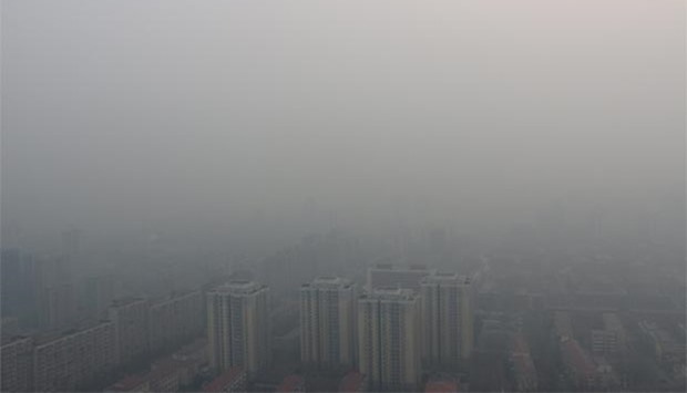 Residential buildings are seen in smog during a polluted day in Beijing.