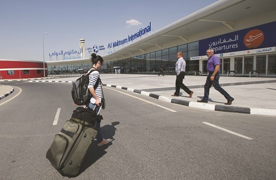 A passenger (left) walks on her way into the Dubai World Central u2013 Al Maktoum International Airport, in Jebel Ali, Dubai (file). The emirate is developing Al Maktoum International Airport close to the Expo 2020 site with an annual capacity of about 220mn passengers and plans to move flagship carrier Emirates by 2025.