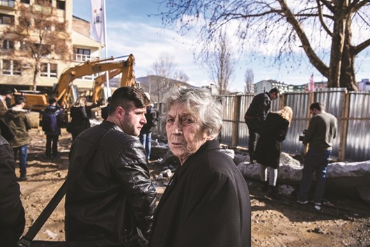 A Serbian woman grimaces as bulldozers take down a concrete wall near the main bridge in the town of Mitrovica, after the Kosovo government reached an agreement with countryu2019s ethnic Serb minority to resolve the issue of a contested wall symbolically dividing the city of Mitrovica.