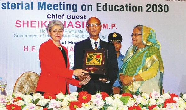 Unesco Director General Irina Bokova handing over a crest to Bangladeshu2019s Education Minister Nurul Islam Nahid in presence of Prime Minister Sheikh Hasina in Dhaka yesterday.