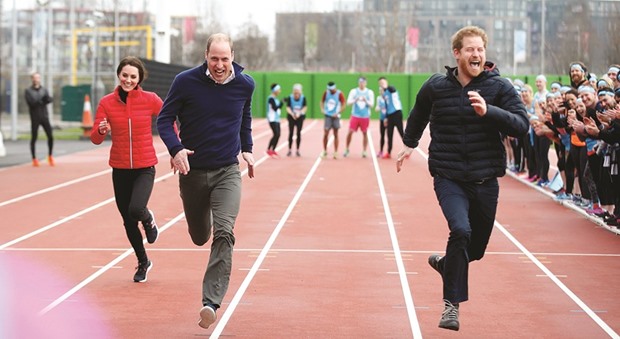Britainu2019s Prince William, Kate, Duchess of Cambridge, and Prince Harry take part in a relay race, during a training event to promote the charity Heads Together, at the Queen Elizabeth II Park in London.