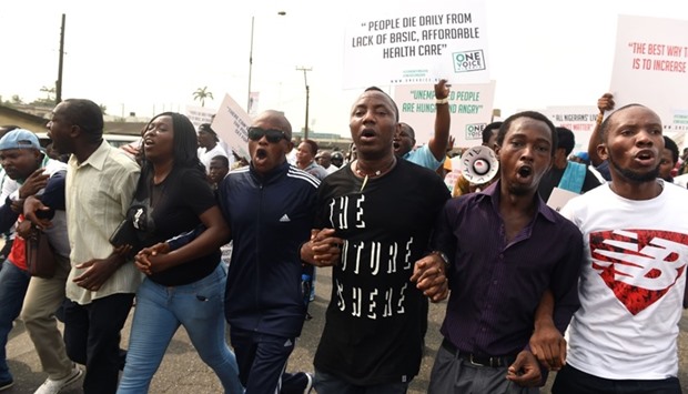 Protesters hold placards and shout slogans during an anti-government demonstration in Lagos. AFP