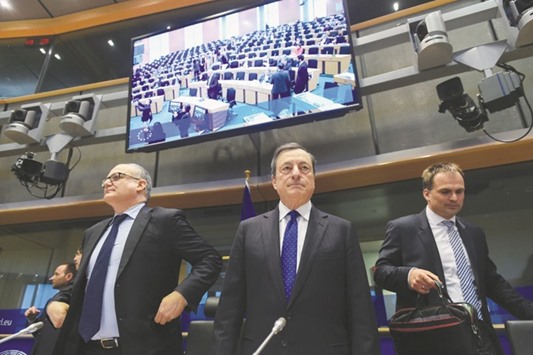 ECB president and chairman of the European Systemic Risk Board, Mario Draghi (centre) attends a hearing of the European Parliament Committee on Economic and Monetary Affairs at the European Parliament in Brussels yesterday. The currency blocu2019s recovery is gaining strength but labour market slack remains large, productivity growth is weak and risks remain tilted to the downside, requiring the ECBu2019s continued help, Draghi told the committee.