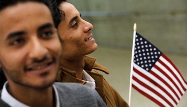 Tareq Aziz and his brother Ammar Aziz, Yemeni nationals who were delayed entry into the US because of the recent travel ban, smile as they are reunited with their family at Washington Dulles International Airport in Chantilly, Virginia, on Monday.